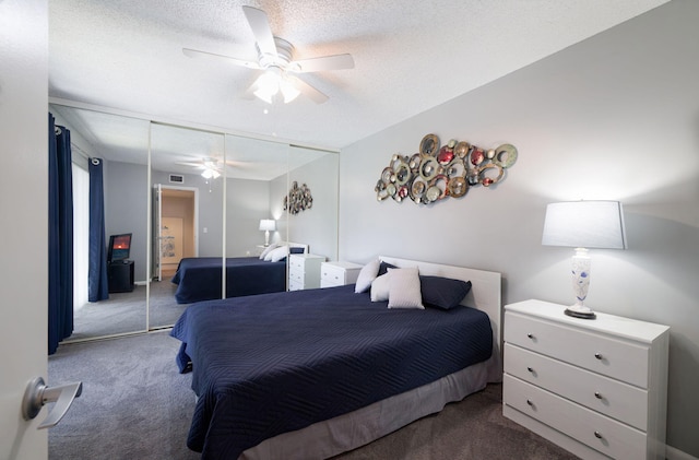 3675 SW Sunset Trace Cir, Palm City, FL 34990 - bedroom featuring carpet floors, a closet, a textured ceiling, and a ceiling fan