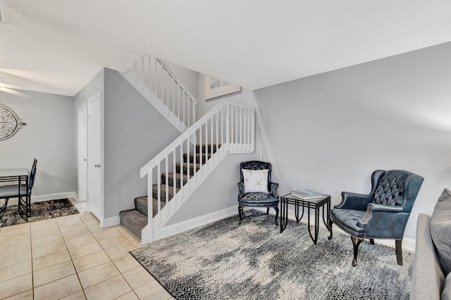 3675 SW Sunset Trace Cir, Palm City, FL 34990 - staircase with tile patterned flooring, a ceiling fan, and a textured ceiling