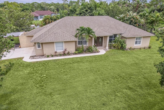 15213 N 93rd St, The Acreage, FL 33412 - ranch-style house with stucco siding, a front yard, roof with shingles, and view of scattered trees
