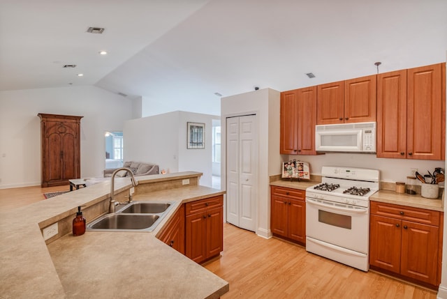 15213 N 93rd St, The Acreage, FL 33412 - kitchen featuring white appliances, open floor plan, light wood-style flooring, and vaulted ceiling