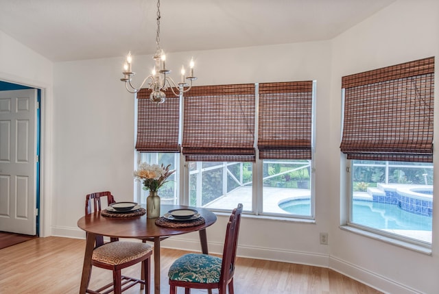 15213 N 93rd St, The Acreage, FL 33412 - dining room featuring a chandelier, light wood finished floors, and healthy amount of natural light