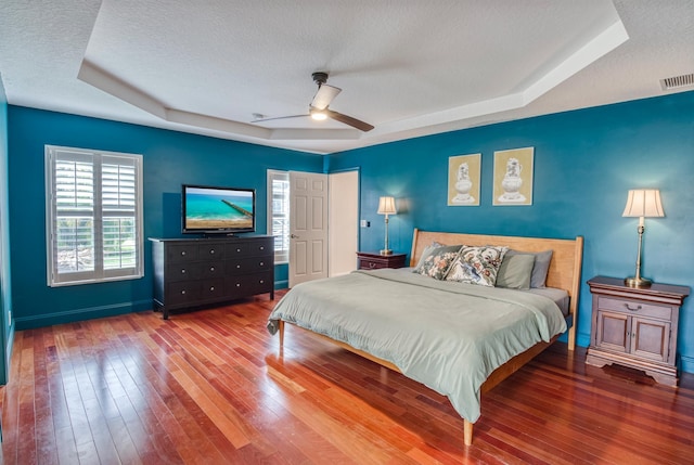 15213 N 93rd St, The Acreage, FL 33412 - bedroom with a tray ceiling, a textured ceiling, hardwood / wood-style floors, and ceiling fan