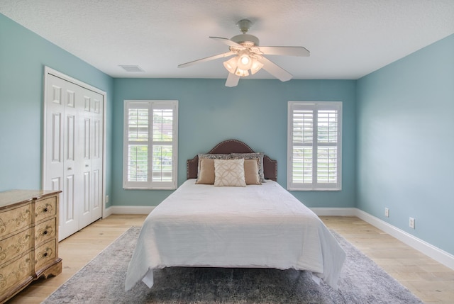 15213 N 93rd St, The Acreage, FL 33412 - bedroom featuring wood finished floors, multiple windows, ceiling fan, and a closet
