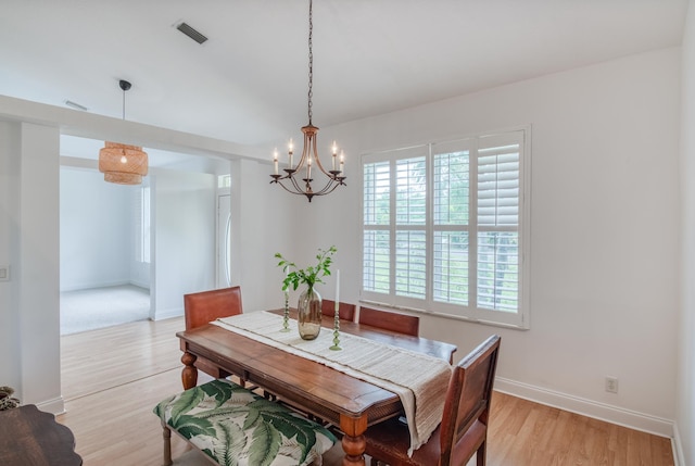 15213 N 93rd St, The Acreage, FL 33412 - dining area with a chandelier, healthy amount of natural light, and light wood-style floors