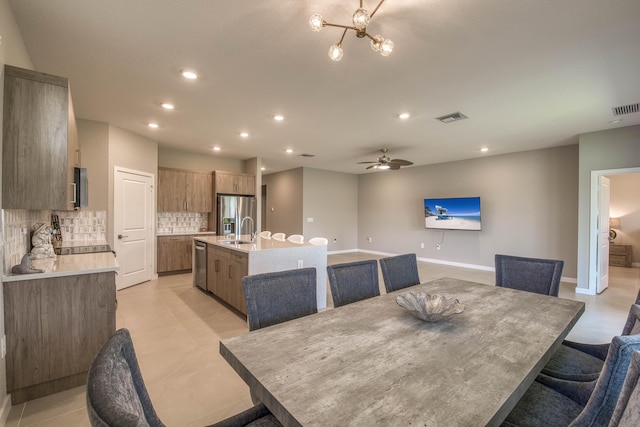 1878 NE Ocean Dunes Dr, Jensen Beach, FL 34957 - dining room with recessed lighting, a ceiling fan, a chandelier, and light tile patterned floors
