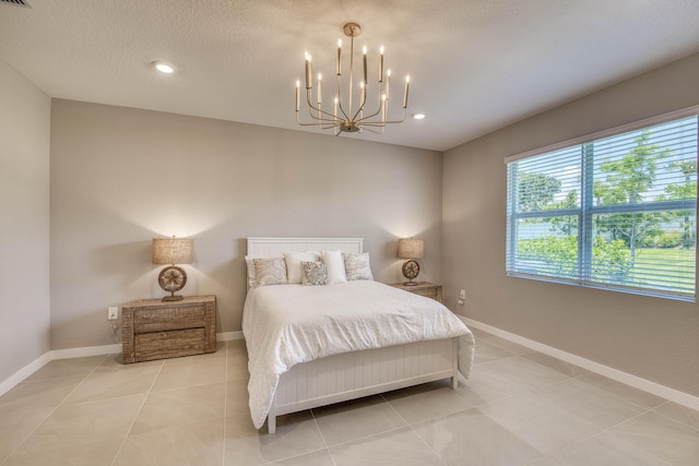 1878 NE Ocean Dunes Dr, Jensen Beach, FL 34957 - bedroom with a chandelier, light tile patterned flooring, and recessed lighting