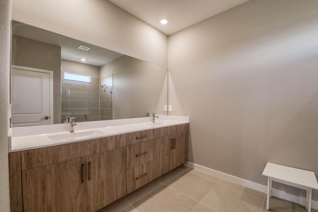 1878 NE Ocean Dunes Dr, Jensen Beach, FL 34957 - full bathroom with double vanity, tiled shower, and tile patterned floors
