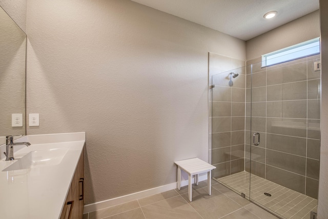 1878 NE Ocean Dunes Dr, Jensen Beach, FL 34957 - bathroom with a tile shower, vanity, and tile patterned flooring