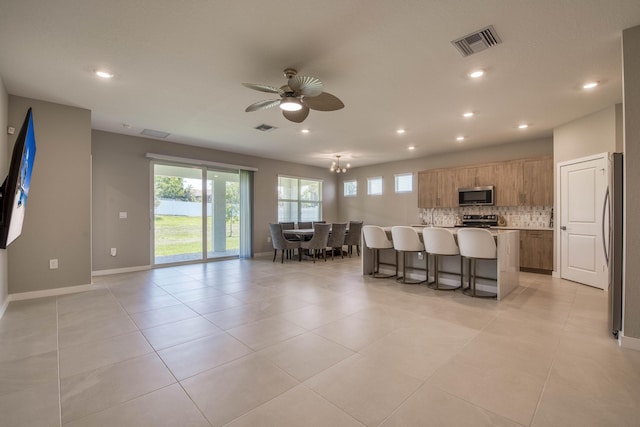 1878 NE Ocean Dunes Dr, Jensen Beach, FL 34957 - kitchen with stainless steel appliances, healthy amount of natural light, a ceiling fan, backsplash, and recessed lighting