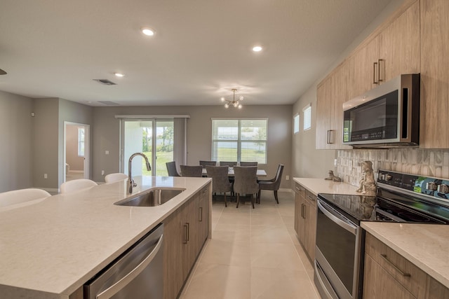 1878 NE Ocean Dunes Dr, Jensen Beach, FL 34957 - kitchen featuring appliances with stainless steel finishes, recessed lighting, light countertops, a center island with sink, and light tile patterned floors