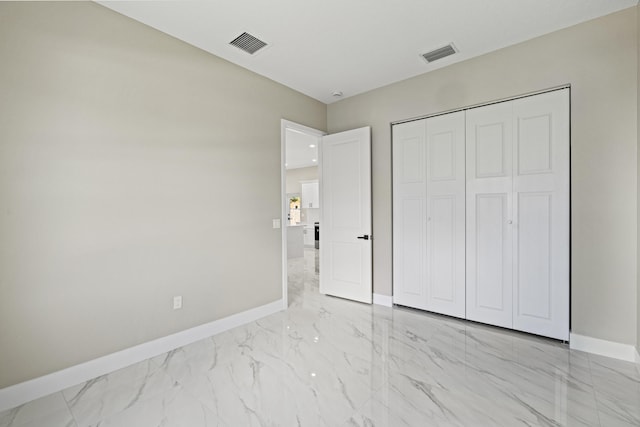3257 SE Snow Rd, Port Saint Lucie, FL 34984 - unfurnished bedroom with light marble finish floors and a closet