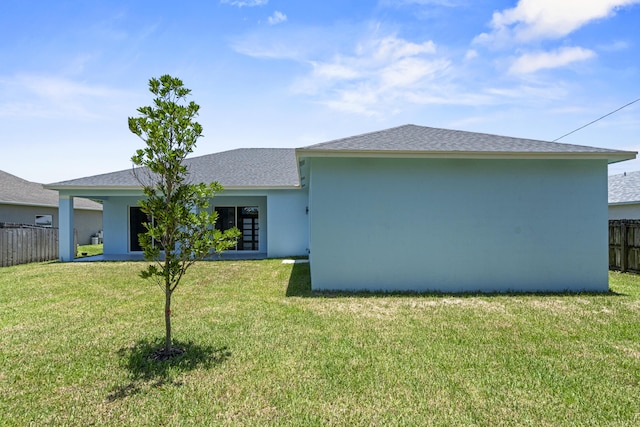 3257 SE Snow Rd, Port Saint Lucie, FL 34984 - rear view of house with stucco siding and roof with shingles