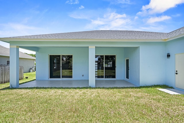 3257 SE Snow Rd, Port Saint Lucie, FL 34984 - back of house featuring stucco siding, a lawn, and a shingled roof