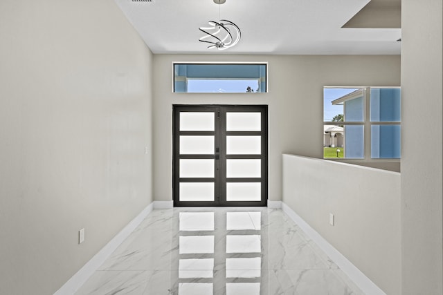 3257 SE Snow Rd, Port Saint Lucie, FL 34984 - foyer entrance with marble look tiles and french doors