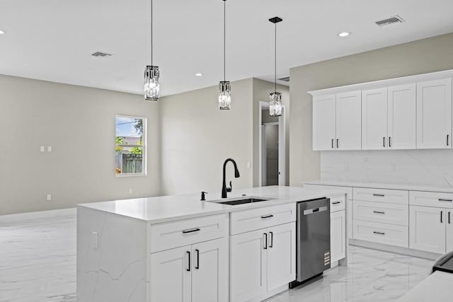 3257 SE Snow Rd, Port Saint Lucie, FL 34984 - kitchen with stainless steel dishwasher, light marble finish flooring, recessed lighting, an island with sink, and light countertops