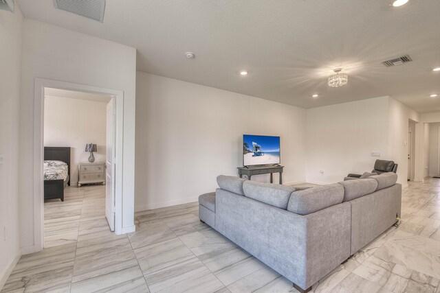 1850 NE Ocean Dunes Dr, Jensen Beach, FL 34957 - living room featuring light marble finish flooring and recessed lighting