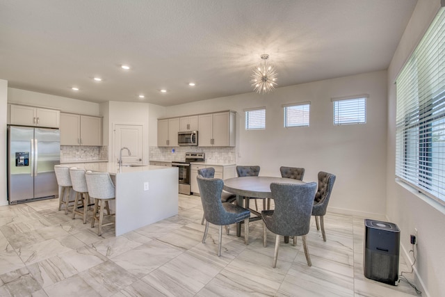 1850 NE Ocean Dunes Dr, Jensen Beach, FL 34957 - dining space with recessed lighting and a chandelier