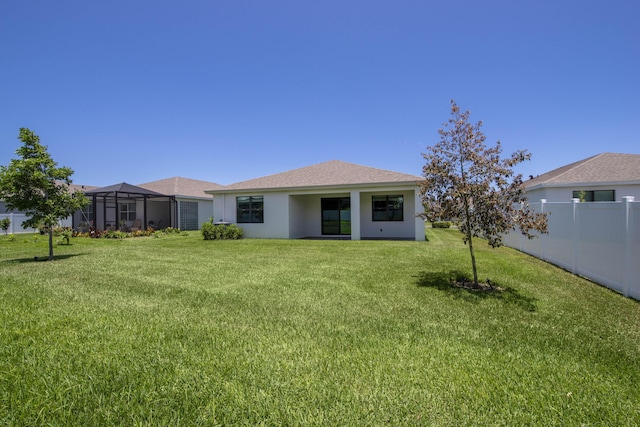 1850 NE Ocean Dunes Dr, Jensen Beach, FL 34957 - rear view of house featuring stucco siding and roof with shingles