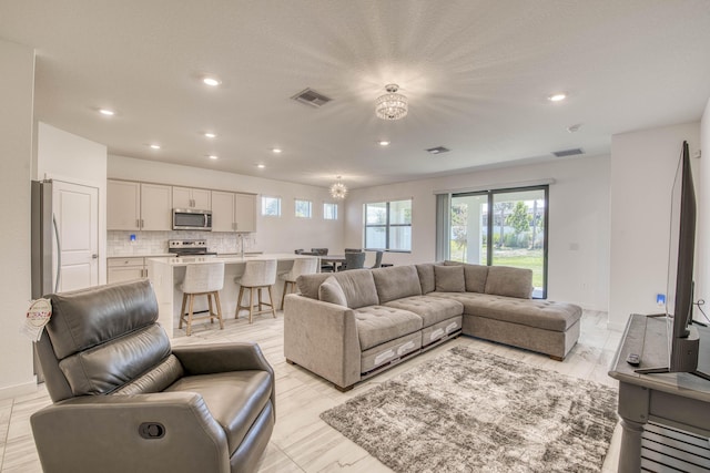 1850 NE Ocean Dunes Dr, Jensen Beach, FL 34957 - living room with a chandelier and recessed lighting