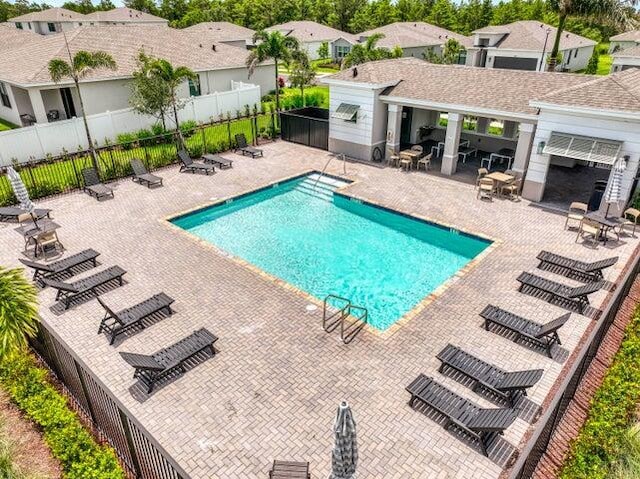 1850 NE Ocean Dunes Dr, Jensen Beach, FL 34957 - community pool with a patio and a residential view