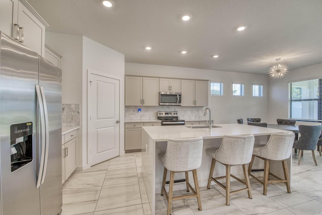 1850 NE Ocean Dunes Dr, Jensen Beach, FL 34957 - kitchen with stainless steel appliances, light marble finish floors, tasteful backsplash, light countertops, and recessed lighting
