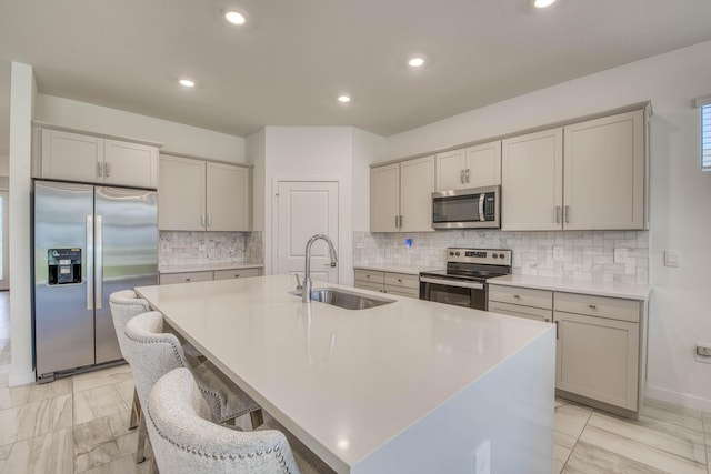 1850 NE Ocean Dunes Dr, Jensen Beach, FL 34957 - kitchen with appliances with stainless steel finishes, an island with sink, decorative backsplash, light countertops, and recessed lighting