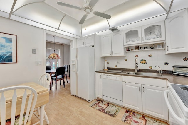 10777 W Sample Rd Unit 207, Coral Springs, FL 33065 - kitchen with white appliances, decorative backsplash, white cabinets, light wood-style floors, and a ceiling fan
