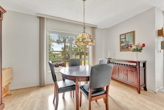 10777 W Sample Rd Unit 207, Coral Springs, FL 33065 - dining space with light wood-style flooring and a textured ceiling