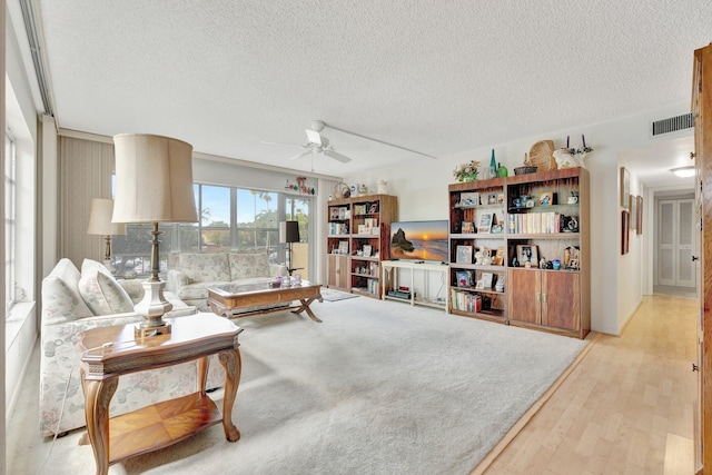 10777 W Sample Rd Unit 207, Coral Springs, FL 33065 - living area with ceiling fan, a textured ceiling, and light wood-style floors