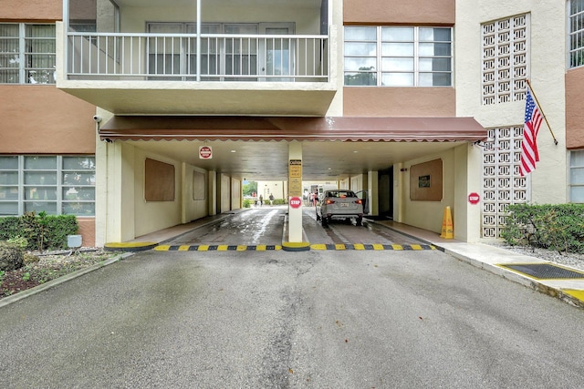 10777 W Sample Rd Unit 207, Coral Springs, FL 33065 - garage featuring a carport and asphalt driveway