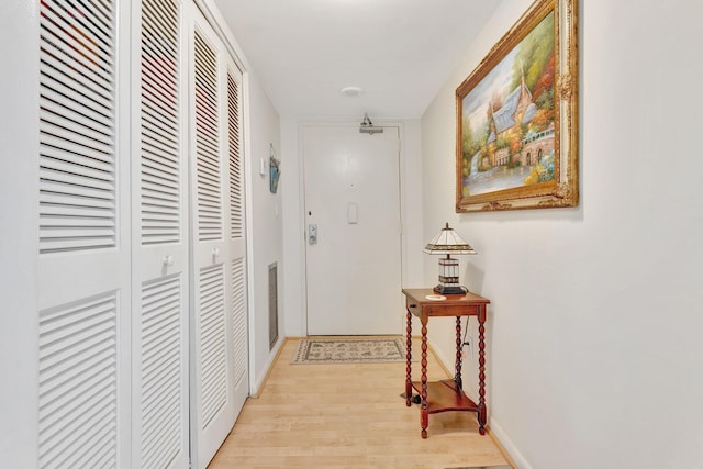 10777 W Sample Rd Unit 207, Coral Springs, FL 33065 - corridor featuring light wood-style flooring and baseboards