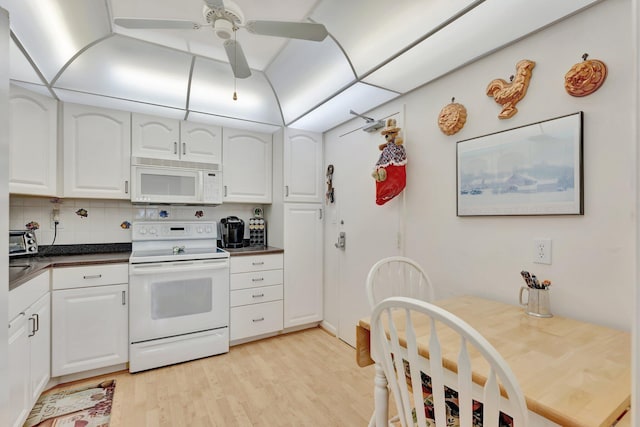 10777 W Sample Rd Unit 207, Coral Springs, FL 33065 - kitchen featuring white appliances, dark countertops, light wood finished floors, white cabinets, and ceiling fan