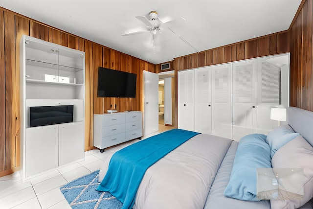 444 Saxony J, Delray Beach, FL 33446 - bedroom with wooden walls, light tile patterned flooring, a closet, and ceiling fan