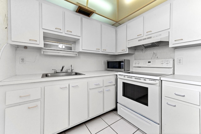 444 Saxony J, Delray Beach, FL 33446 - kitchen featuring white range with electric cooktop, under cabinet range hood, stainless steel microwave, light countertops, and white cabinetry