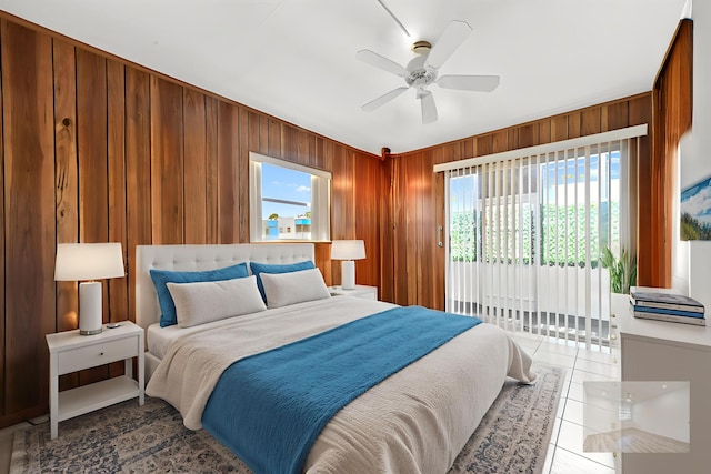 444 Saxony J, Delray Beach, FL 33446 - tiled bedroom featuring wooden walls, access to outside, and a ceiling fan