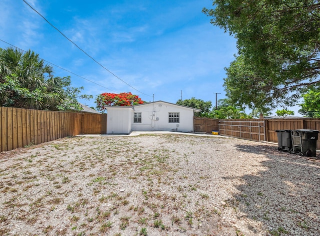 1303 NW 2nd St, Delray Beach, FL 33444 - rear view of house featuring a fenced backyard