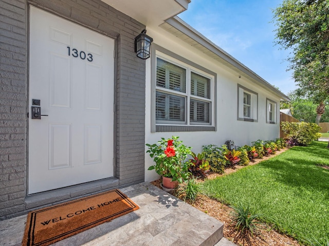 1303 NW 2nd St, Delray Beach, FL 33444 - property entrance with a lawn and brick siding