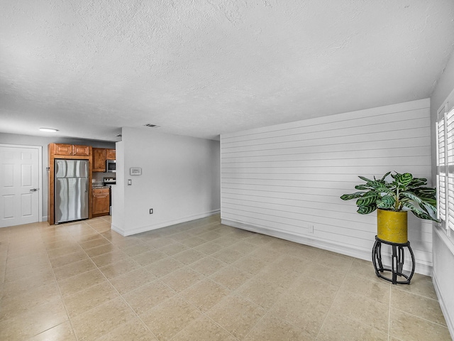1303 NW 2nd St, Delray Beach, FL 33444 - unfurnished living room featuring a textured ceiling