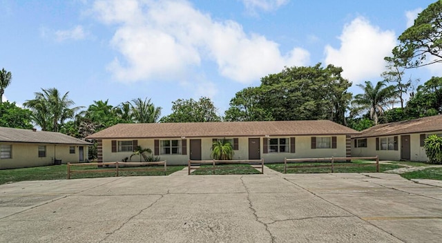732 Neil Rd Unit 1-4, West Palm Beach, FL 33415 - ranch-style home with a fenced front yard and stucco siding