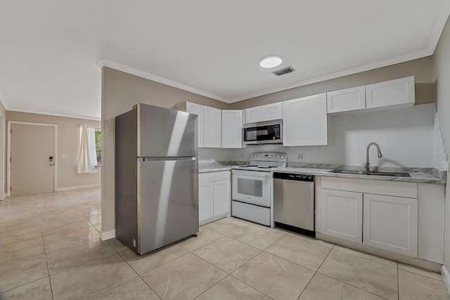 732 Neil Rd Unit 1-4, West Palm Beach, FL 33415 - kitchen featuring stainless steel appliances, ornamental molding, white cabinetry, and light countertops