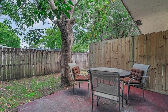 732 Neil Rd Unit 1-4, West Palm Beach, FL 33415 - fenced backyard featuring a patio area and outdoor dining space