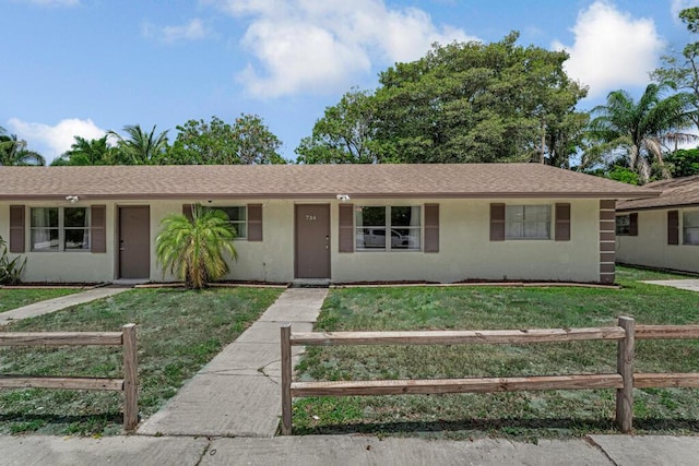 732 Neil Rd Unit 1-4, West Palm Beach, FL 33415 - ranch-style house with a fenced front yard and stucco siding