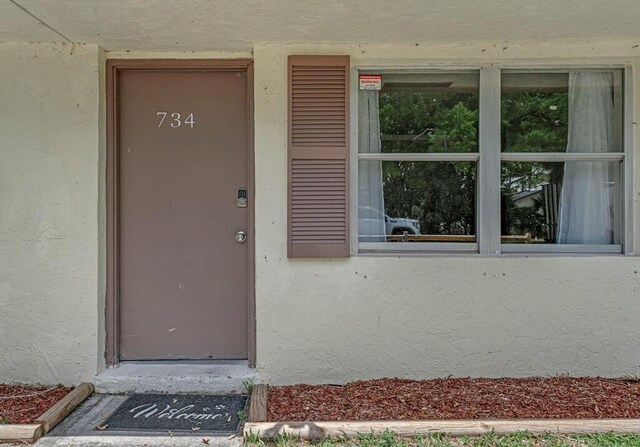 732 Neil Rd Unit 1-4, West Palm Beach, FL 33415 - doorway to property with stucco siding