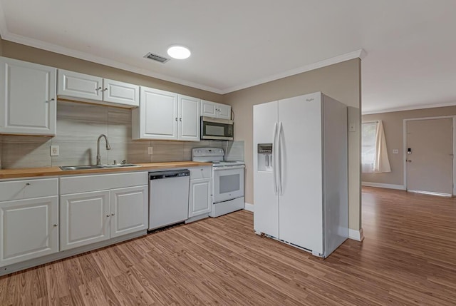 732 Neil Rd Unit 1-4, West Palm Beach, FL 33415 - kitchen with white appliances, ornamental molding, wood counters, light wood finished floors, and white cabinets