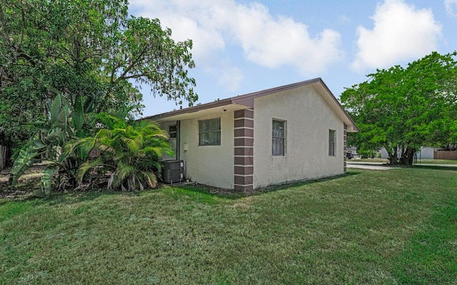 732 Neil Rd Unit 1-4, West Palm Beach, FL 33415 - view of side of property with stucco siding and a lawn