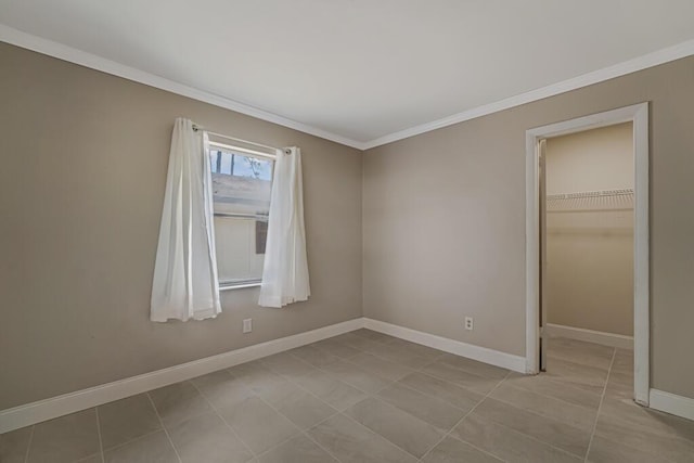 732 Neil Rd Unit 1-4, West Palm Beach, FL 33415 - unfurnished bedroom featuring crown molding, a spacious closet, a closet, and tile patterned floors
