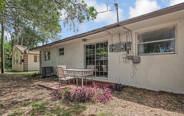 732 Neil Rd Unit 1-4, West Palm Beach, FL 33415 - rear view of property featuring stucco siding, a patio, and a storage shed