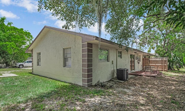 732 Neil Rd Unit 1-4, West Palm Beach, FL 33415 - view of property exterior with a central AC unit and stucco siding