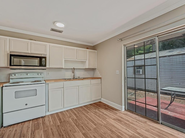 732 Neil Rd Unit 1-4, West Palm Beach, FL 33415 - kitchen with stainless steel microwave, white electric stove, ornamental molding, light wood finished floors, and wood counters