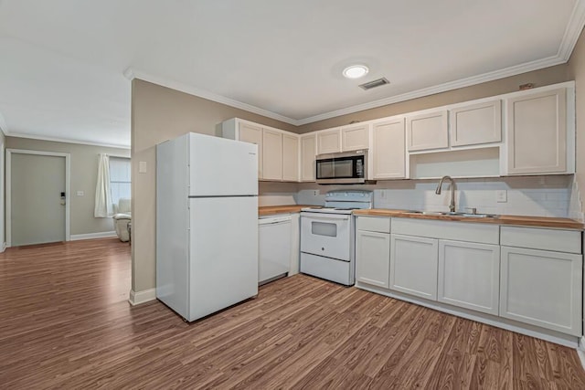 732 Neil Rd Unit 1-4, West Palm Beach, FL 33415 - kitchen featuring white appliances, crown molding, wood finished floors, and butcher block counters